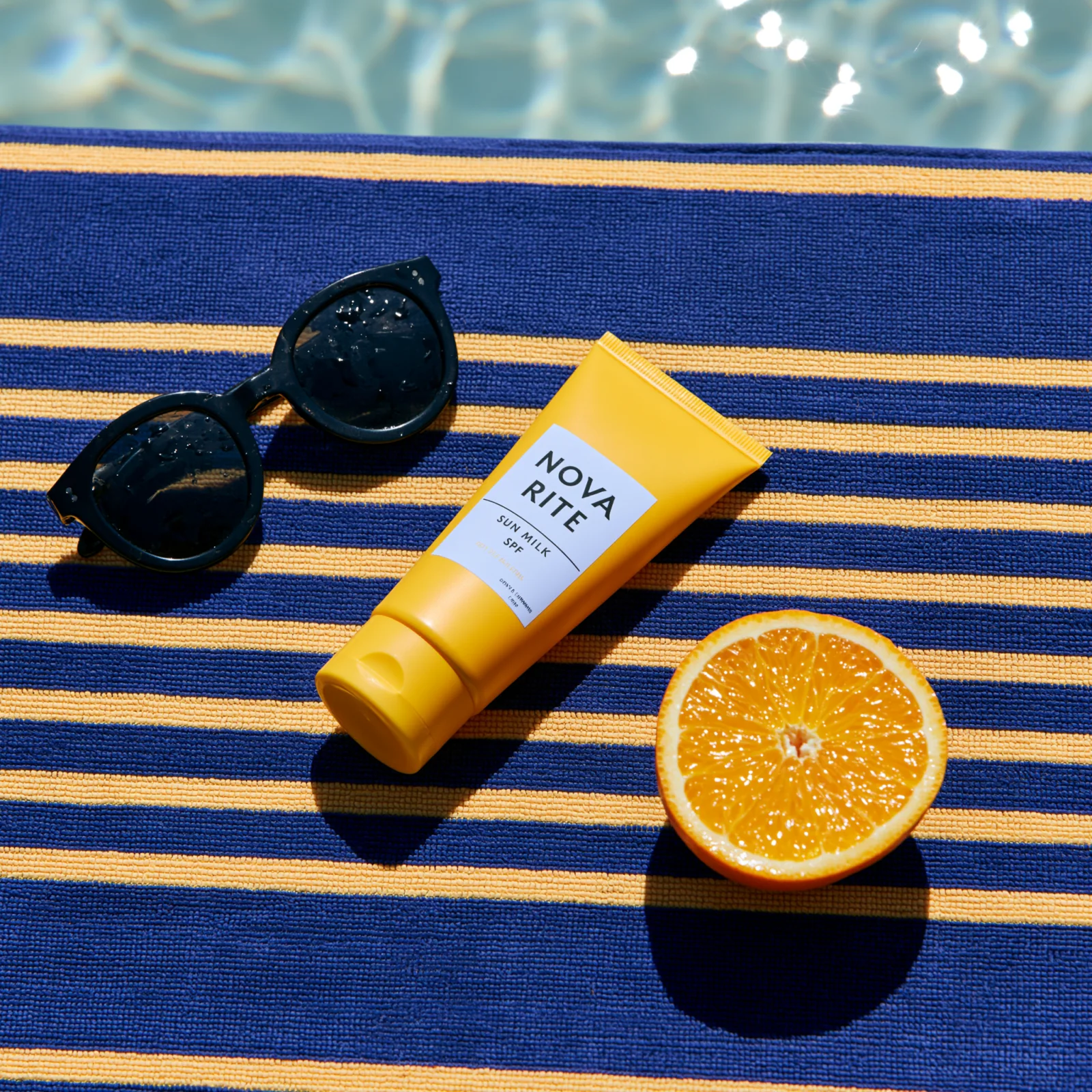 Butter-yellow sunscreen tube on a bright blue pool campaign background