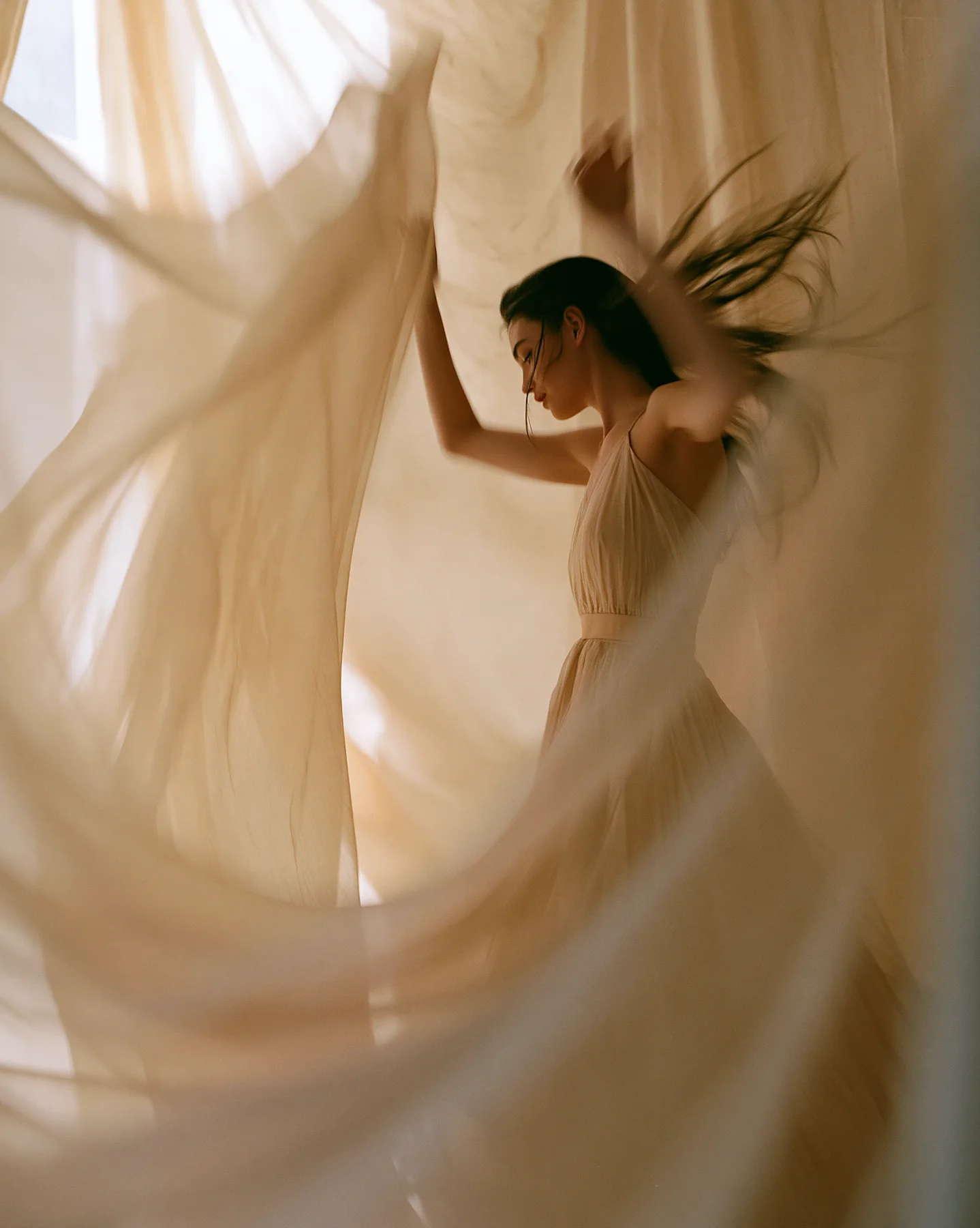 Fashion editorial with adult model in pale gold flowing dress