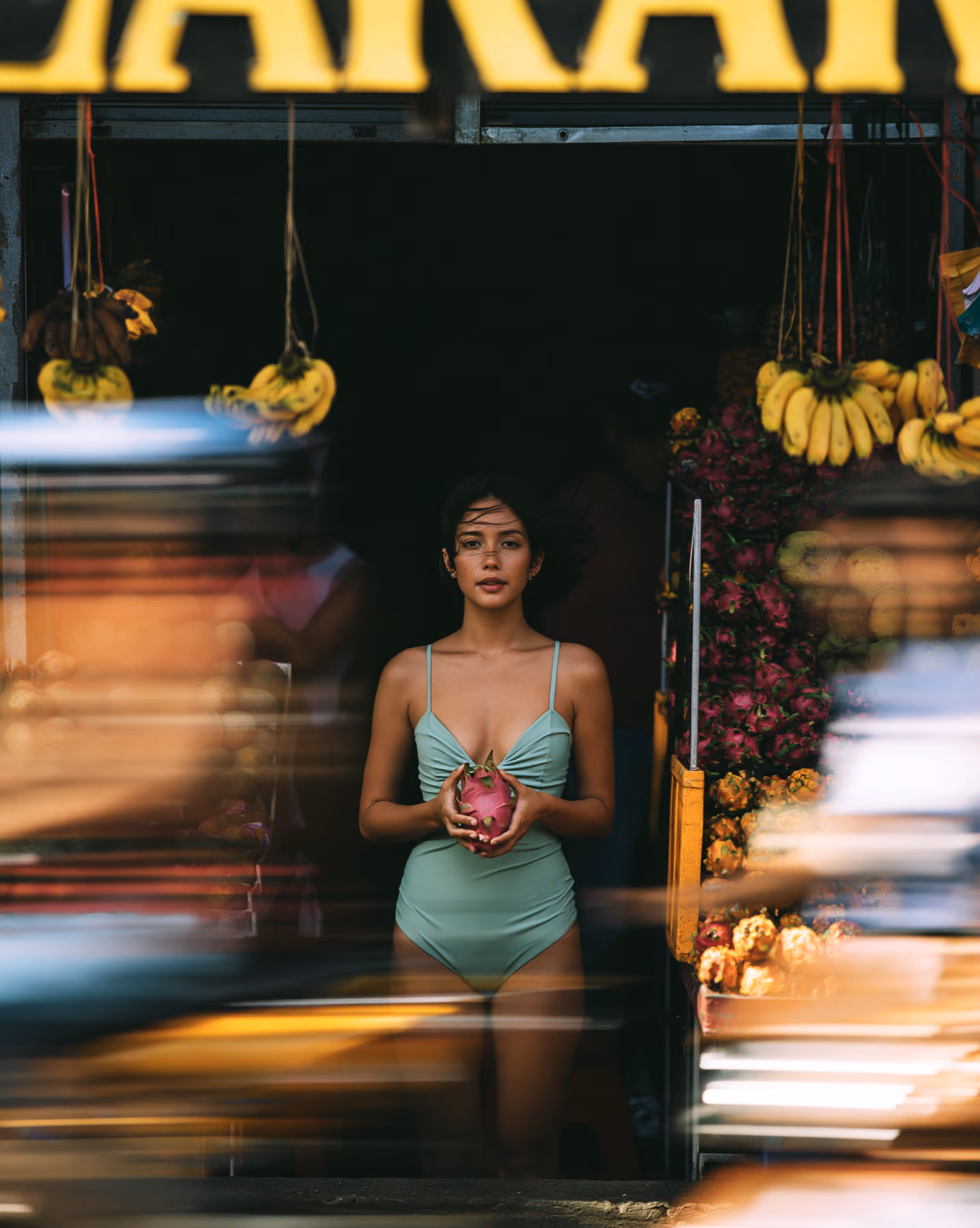 Fashion portrait in a tropical market with motion blur